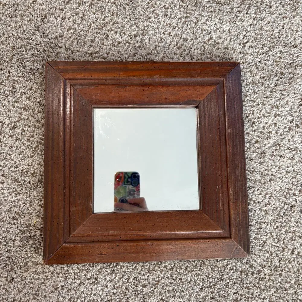 Vintage-style, square wall mirror features a thick, beveled solid wood frame